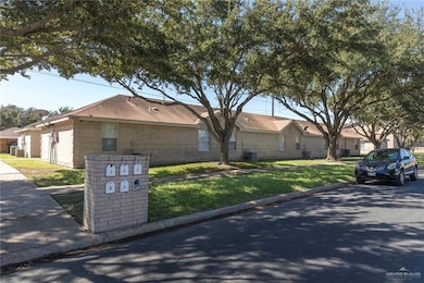 View of front of home featuring brick siding and a front lawn