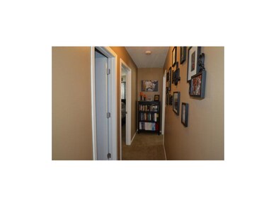 Hallway to full bath on left and 3 bedrooms.