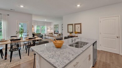 Kitchen featuring sink, white cabinets, a center i