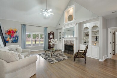 Living room featuring high vaulted ceiling, hardwood / wood-style flooring, and ceiling fan
