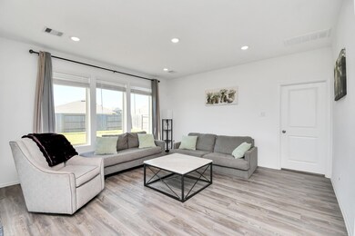 Another look at the living room with a view out to the backyard - plenty of room for even more furniture!