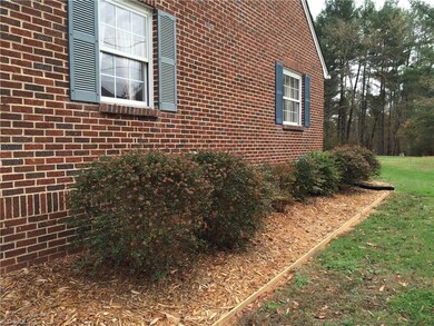 Right exterior view showing new mulch and low maintenance shrubbery.