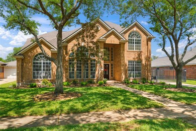The manicured lawn and charming front walkway crea