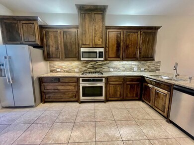 Kitchen featuring gas range with vent-out, sink st