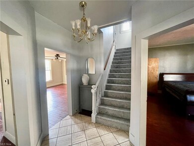 Stairway with ceiling fan with notable chandelier 
