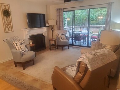 Living area featuring a fireplace and ceiling fan