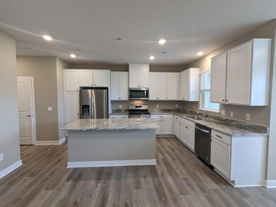 Kitchen with oversized island.  Photo is of actual home.