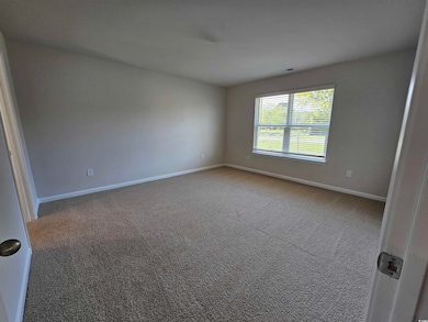 Carpeted empty room with baseboards