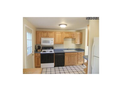 This space provides pretty hickory cabinetry with 