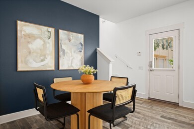 Dining space with wood finished floors and basebo