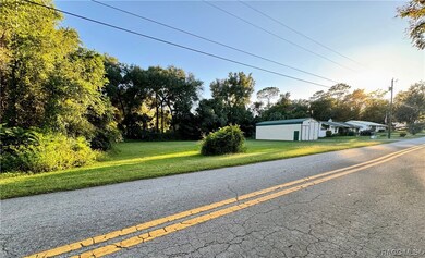 PHOT OF OPEN LOT + RV GARAGE + HOME
