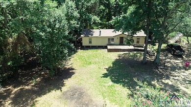 View of grassy yard featuring a deck