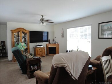 Living room w/ corner fireplace.