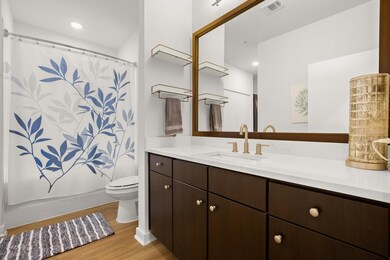 Full bathroom featuring vanity and wood finished 