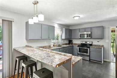 Kitchen featuring stainless steel appliances, a si