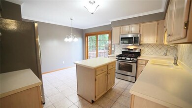 Eat in kitchen, SS appliances, 5-burner gas stove, dble sink w/ sprayer, pantry, island, backsplash, & bright slider to the deck.