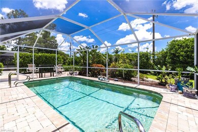 Enclosed pool surrounded with deck pavers and lush landscaping
