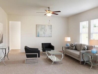 Living room with carpet floors and a ceiling fan