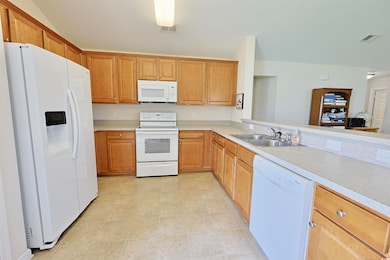 Kitchen with white appliances and light countertops