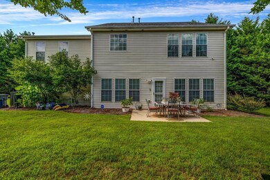 Back of property featuring a patio and a yard