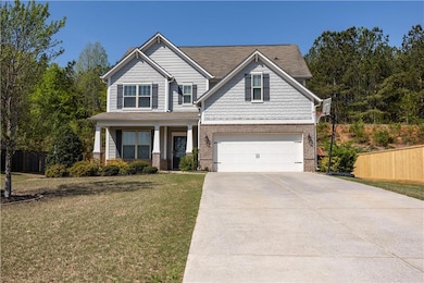 Craftsman house featuring concrete driveway, covered porch, brick siding, and a garage