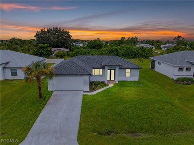 View of front of house featuring concrete driveway, a garage, stucco siding, and a yard