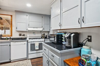 Kitchen with white appliances, under cabinet range
