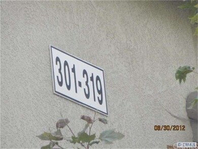 301-319 on front of building hidden behind trees