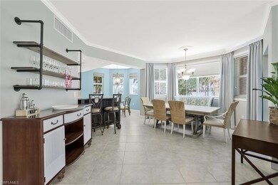 Dining space featuring a chandelier, crown molding, and light tile patterned flooring