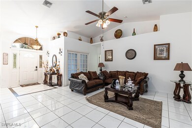 Living room with vaulted ceiling and ceiling fan