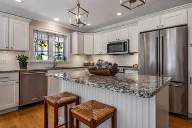 Stunning kitchen with white shaker cabinets, stain