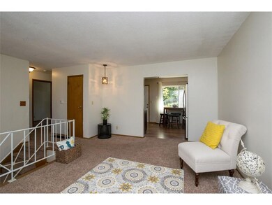 Living room with a view of the backyard and hall t