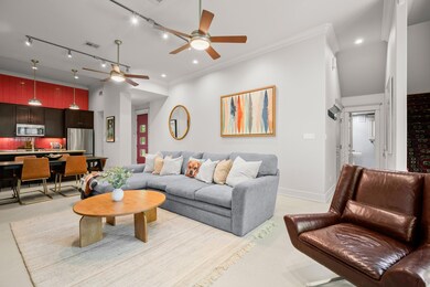 Living room with a ceiling fan, ornamental moldin