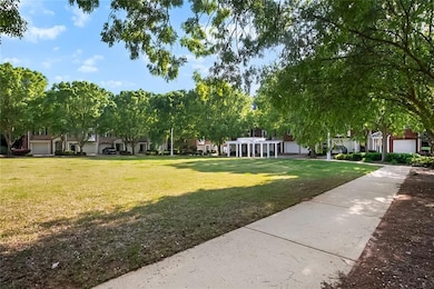 Surrounding community with a lawn, a garage, and a residential view