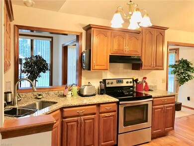 Kitchen with granite countertops and opening to Li