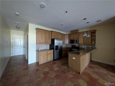 Kitchen with stainless steel appliances, a peninsula, backsplash, open shelves, and vaulted ceiling