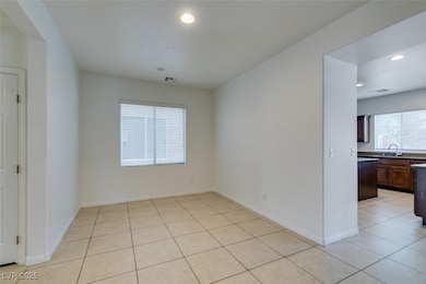 Empty room with light tile patterned floors and recessed lighting