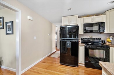 Black appliances contrast nicely with cabinets.