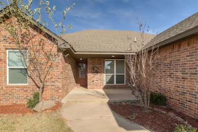 Entrance to property featuring a shingled roof and brick siding