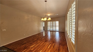 Unfurnished room with an inviting chandelier, a te