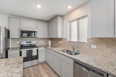 Kitchen with light countertops, decorative backspl