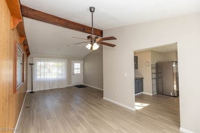 Unfurnished living room with light wood-style floors and ceiling fan