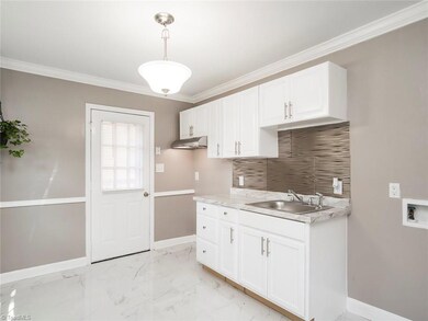 Kitchen with new cabinets, hardware and light fixtures.