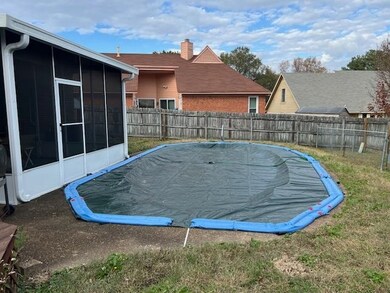 View of swimming pool with a lawn and a sunroom