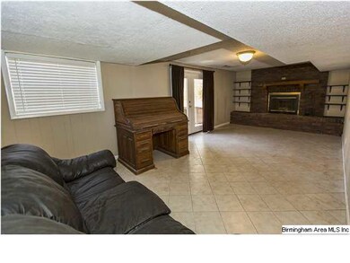 Basement den with ceramic tile, access to yard and
