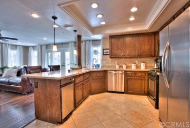 Kitchen has Travertine and Opens to the Family Roo