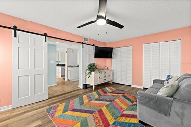 Spacious guest bedroom with luxurious barn doors.
