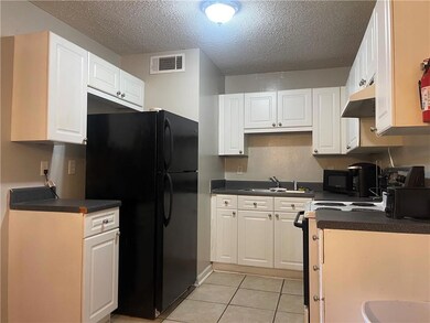 Kitchen featuring black appliances, under cabinet 