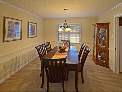 Formal dining room with large window, chandelier, 