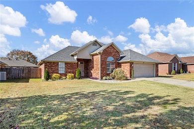 View of front of property featuring brick siding, driveway, an attached garage, and roof with shingles